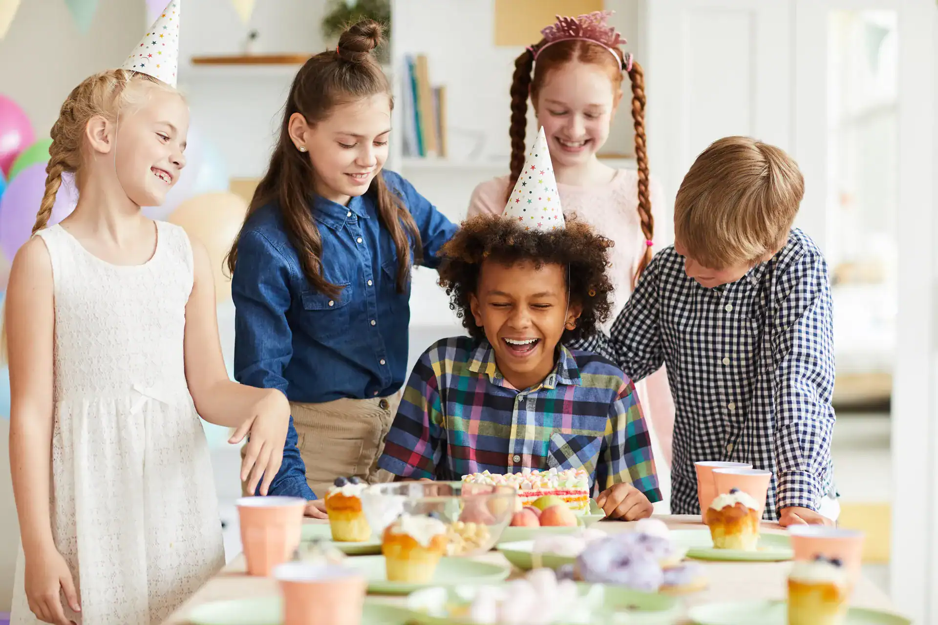Children celebrating a birthday with cake
