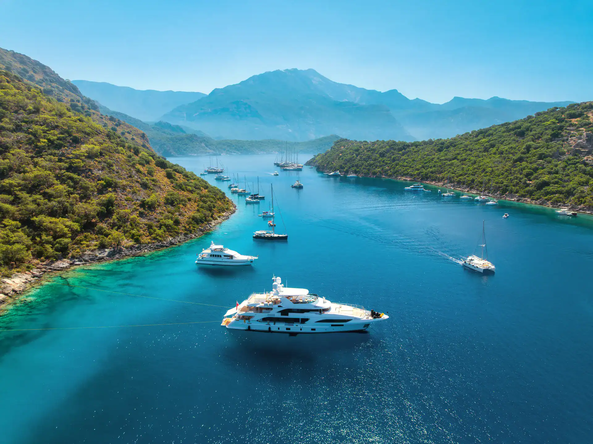 Yachts moored on the water at sunset
